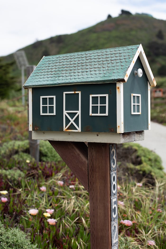 Brown and White Wooden Mail Box on Brown Wooden Post